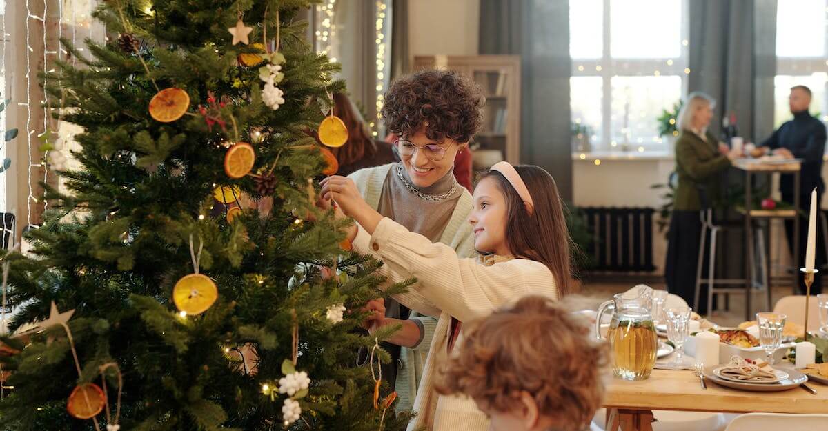 family decorating a Christmas tree