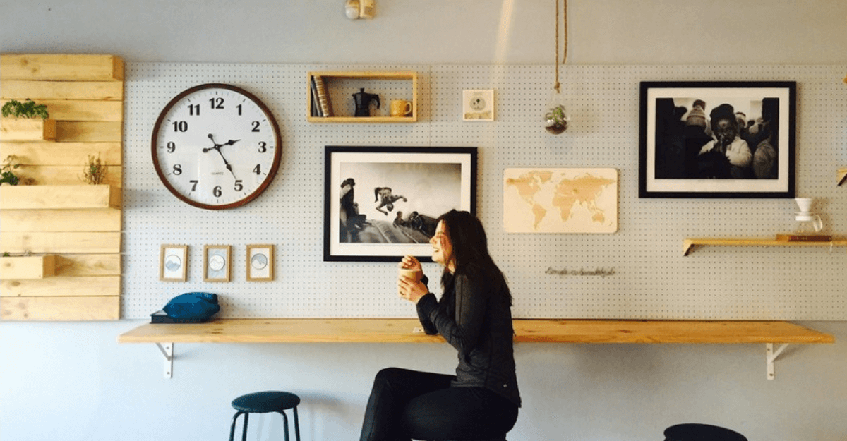 woman sitting on stall near wall mounted desk